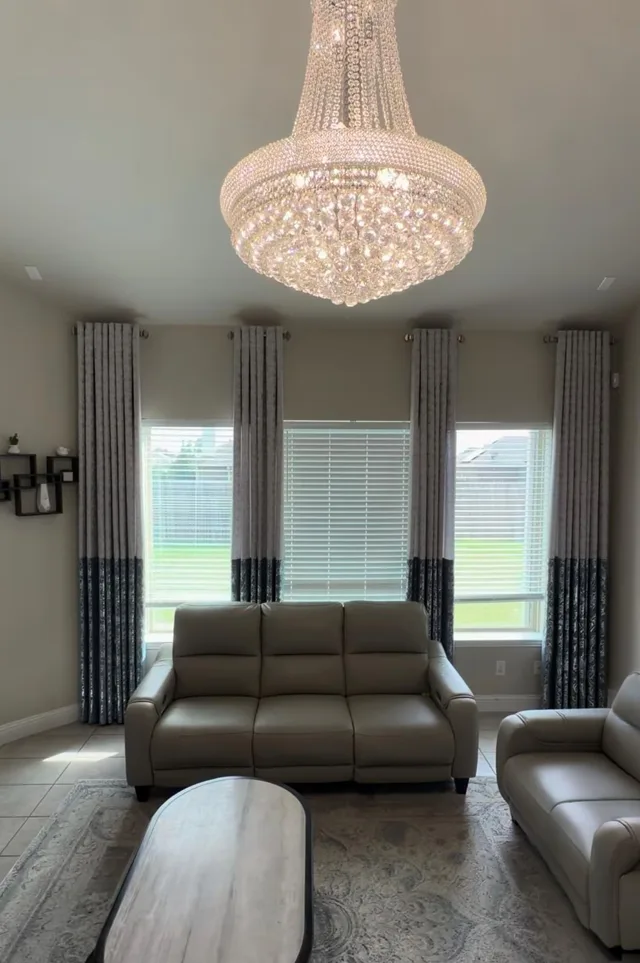 Gray and navy color-block curtain panels framing white horizontal blinds in a living room.